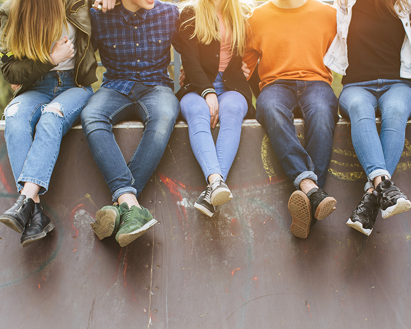 Teens sitting on a ledge; support group for teens in PA