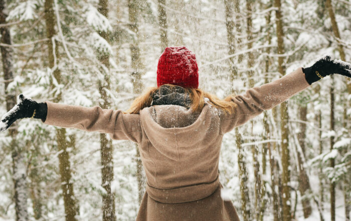 Woman in a forest in winter. How to beat the winter blues.